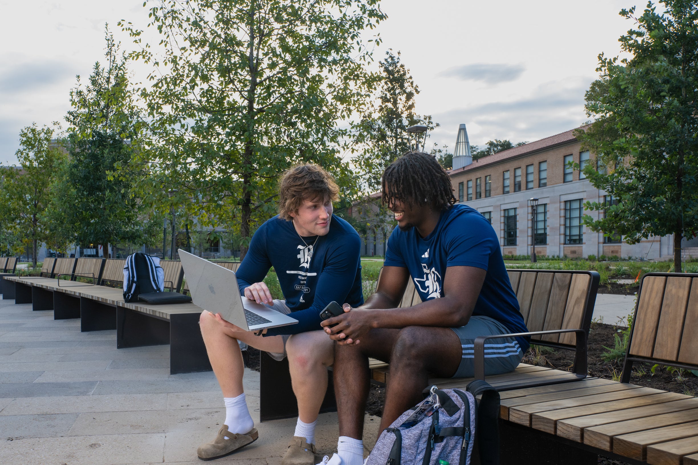 Students talking on bench 